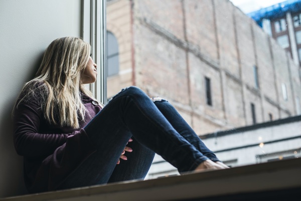 Woman looking out window